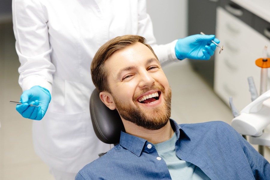 Patient smiling in the dental chair after a general dentistry visit
